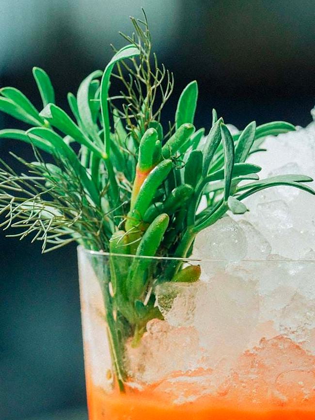 Cocktail with fresh herb garnish and crushed ice
