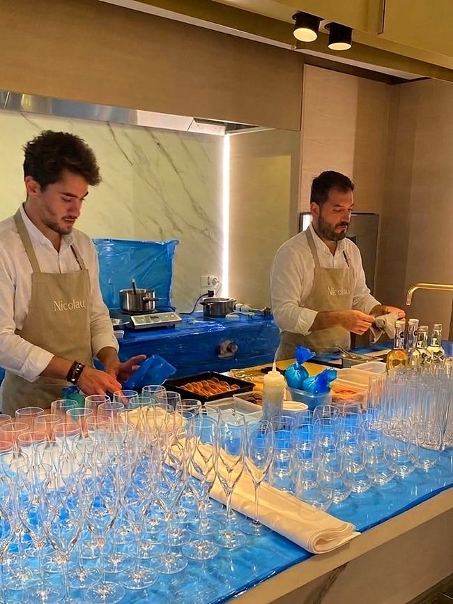 Alejandro and a bartender preparing champagne glasses